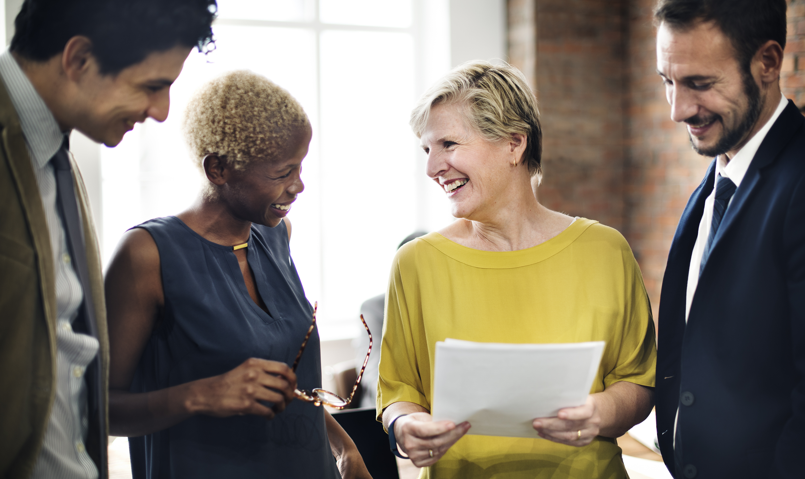Women professionals collaborating and reviewing paperwork together